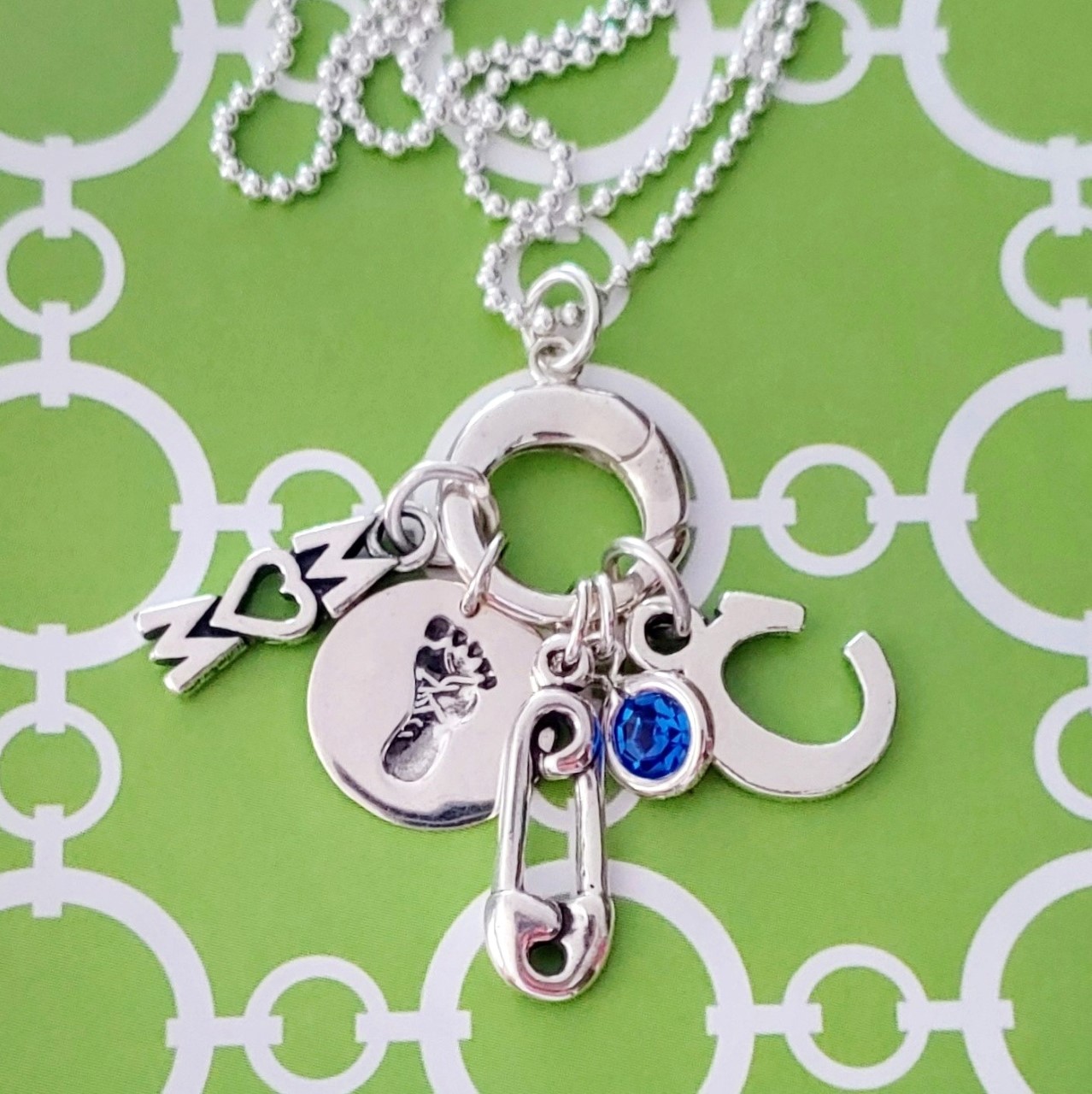 sterling silver charm holder with baby themed charms